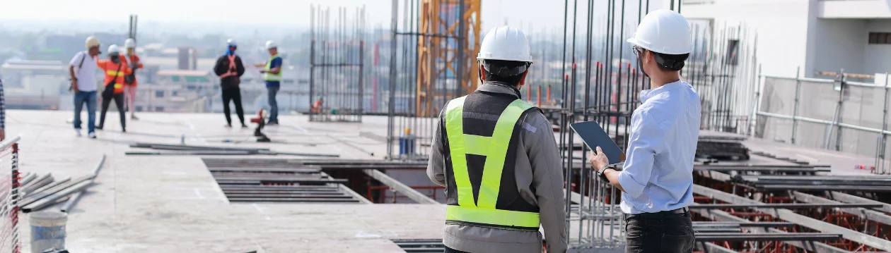 Owner rep reviewing project data on a construction site with tablet